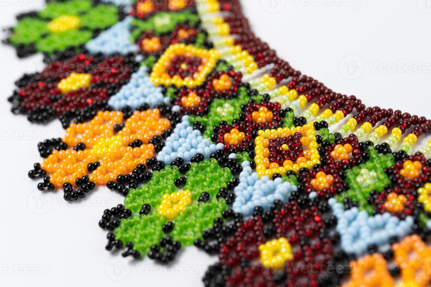 handmade colorful bead necklace close-up isolated on white background. photo