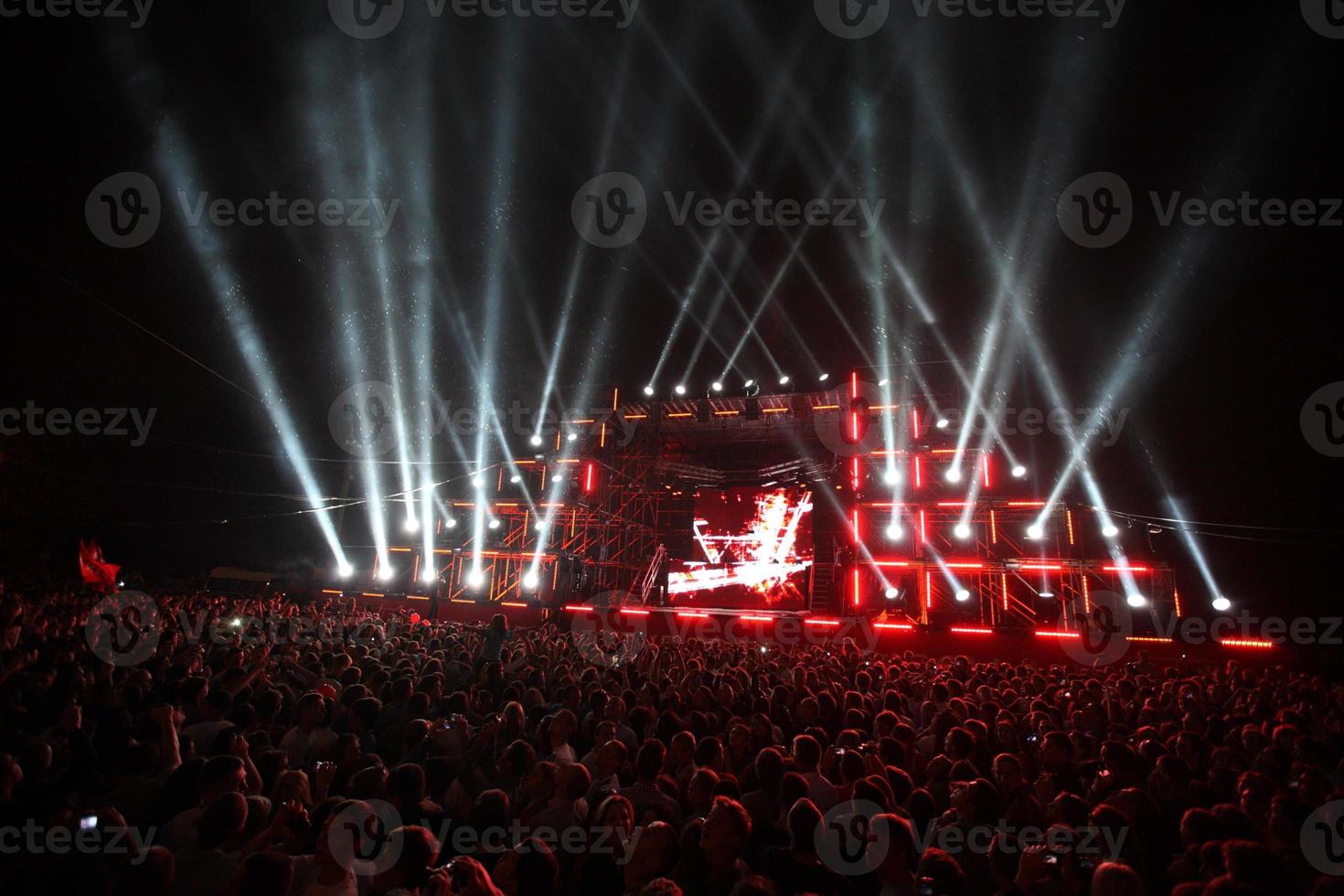 salute and fireworks on a music stage with spotlights at night. photo