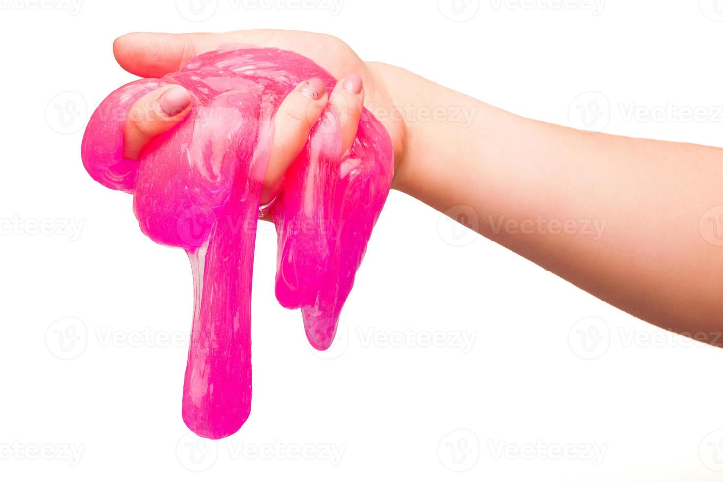a toy for children mucus and liquid flowing on hand on a white background photo