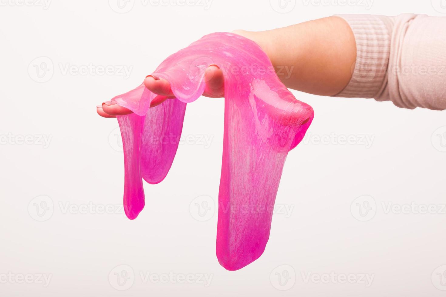 a toy for children mucus and liquid flowing on hand on a white background photo