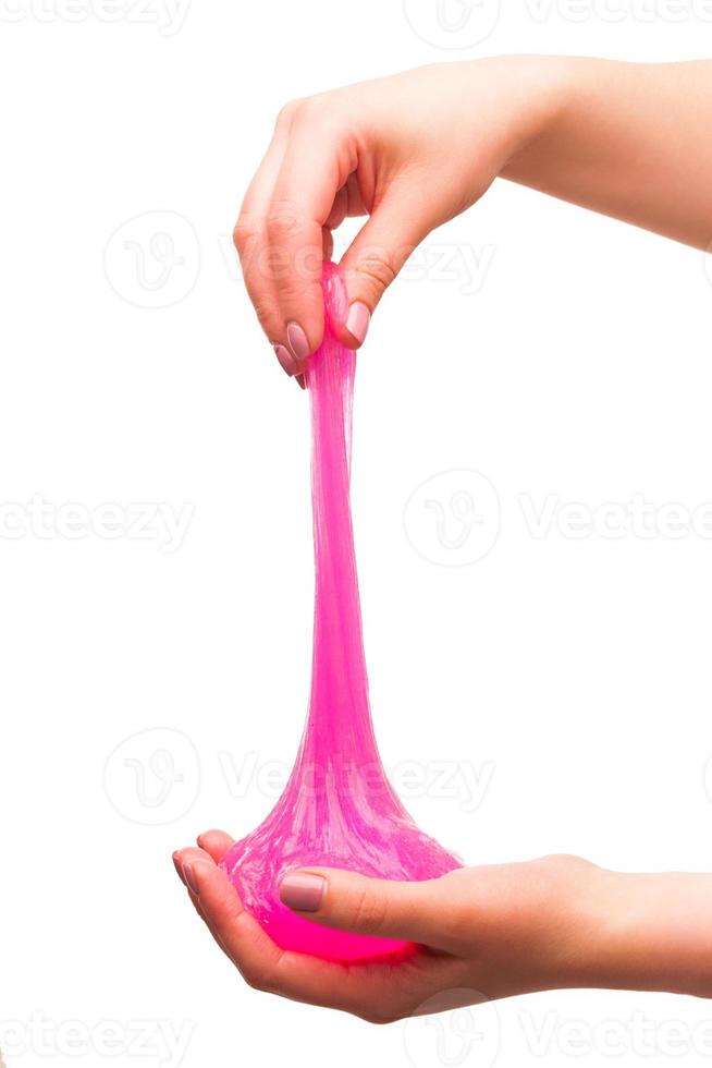 a toy for children mucus and liquid flowing on hand on a white background photo