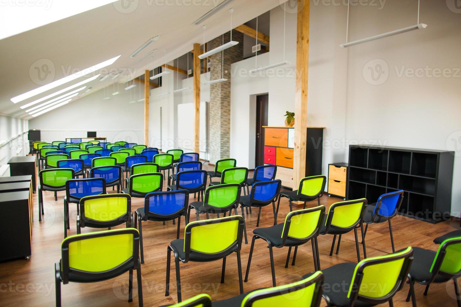 modern lecture room with with colored chairs and interesting design photo