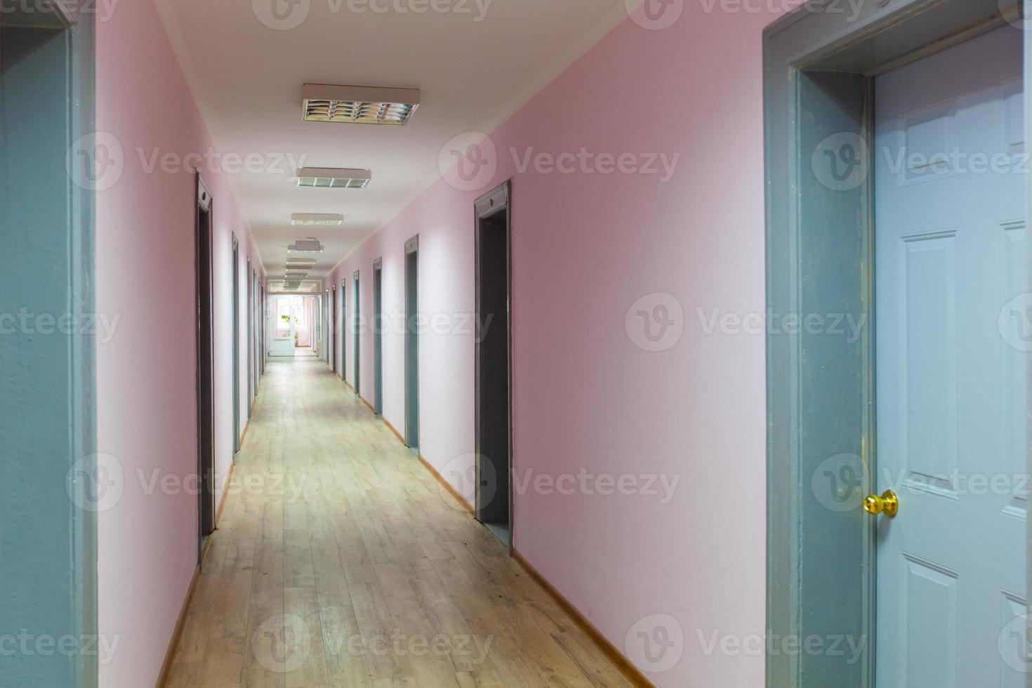 perspective of the empty corridor with many doors photo