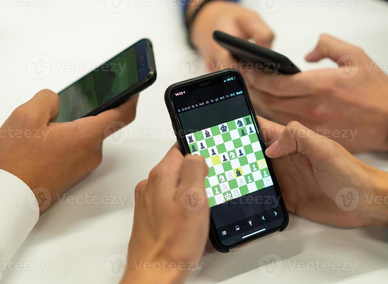 friends play chess on their smartphones online. 17623174 Stock Photo at  Vecteezy