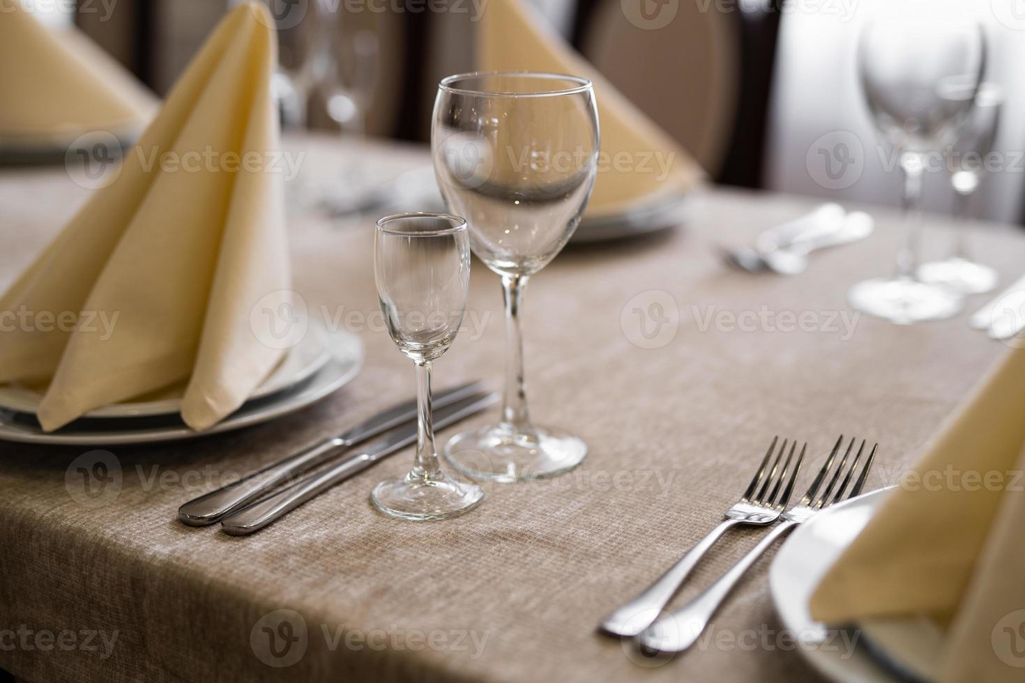 empty goblets and other cutlery are served on the festive table. photo