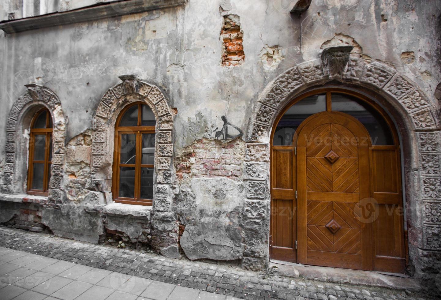 ancient facade of the house, old doors and windows photo