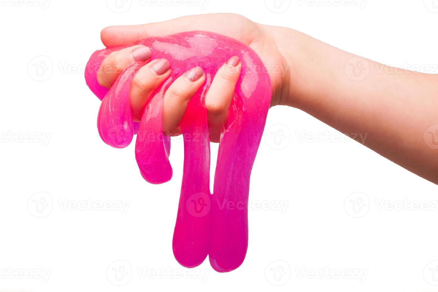 a toy for children mucus and liquid flowing on hand on a white background photo