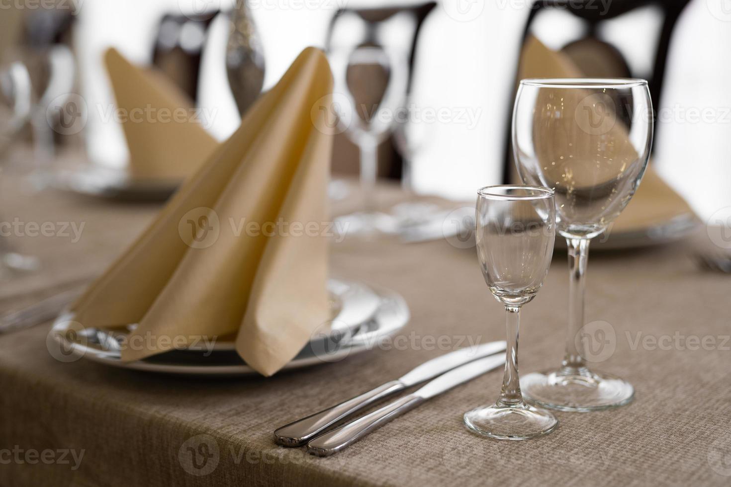 empty goblets and other cutlery are served on the festive table. photo