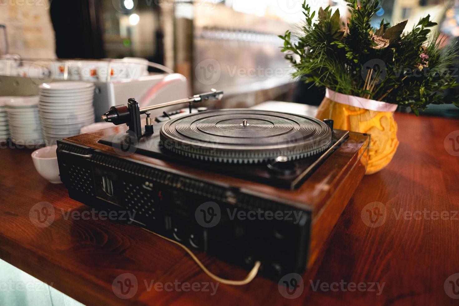 old retro vinyl record player on the table. photo