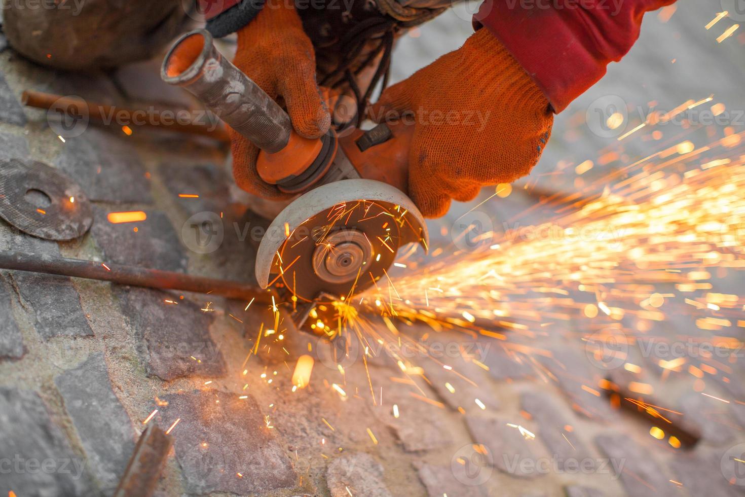 Angular grinding machine cuts metal with sparks photo