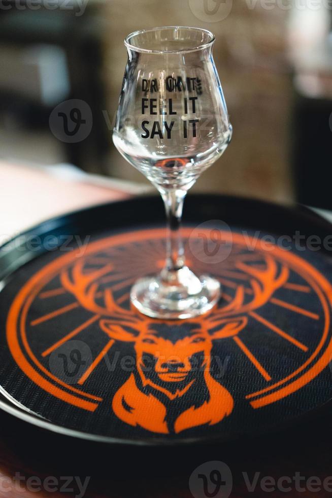 alcohol glass on a tray on a bar with a deer. photo