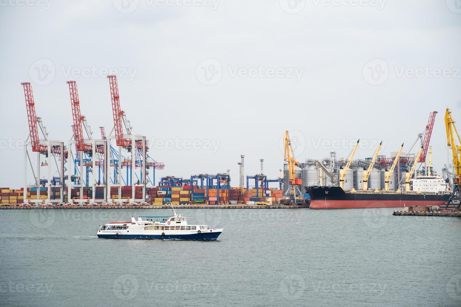 seaport where large cranes are loaded containers on cargo ships photo