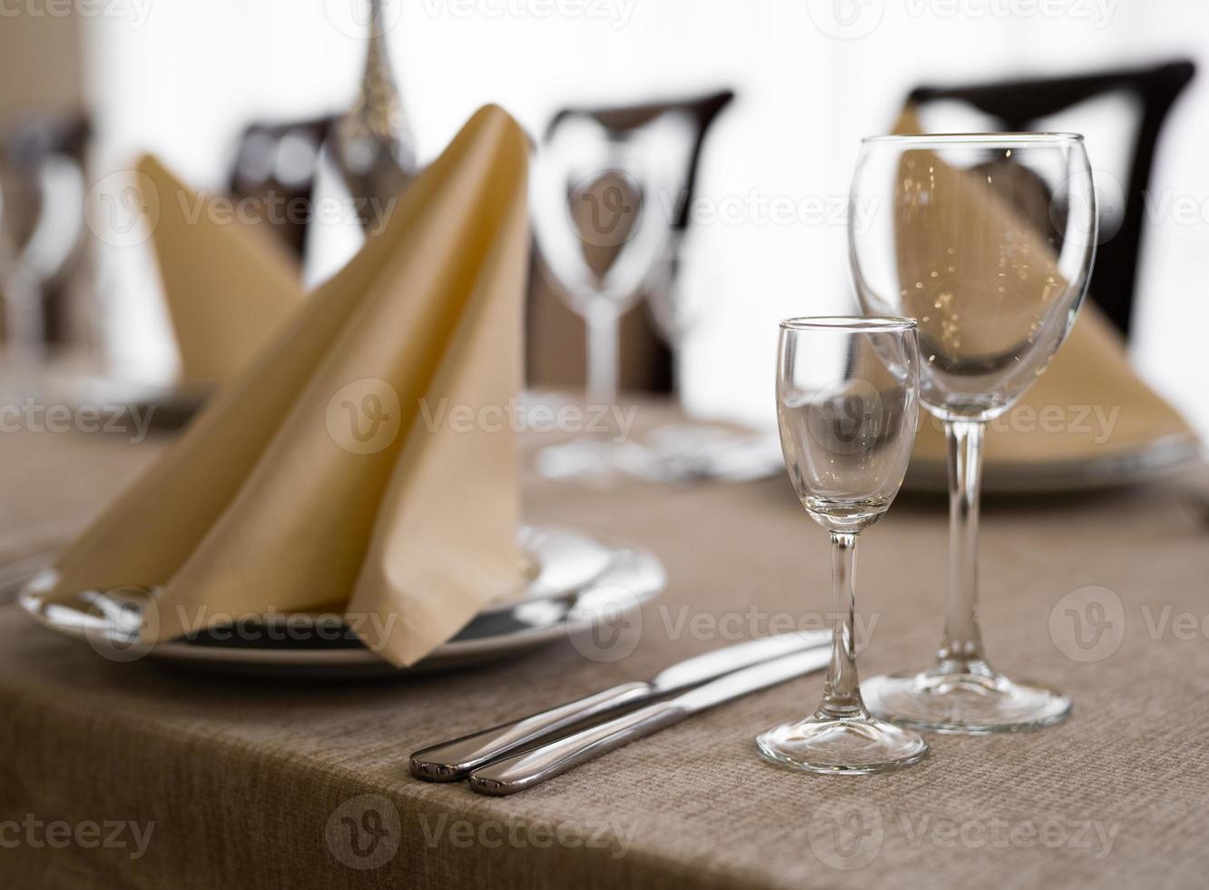 empty goblets and other cutlery are served on the festive table. photo