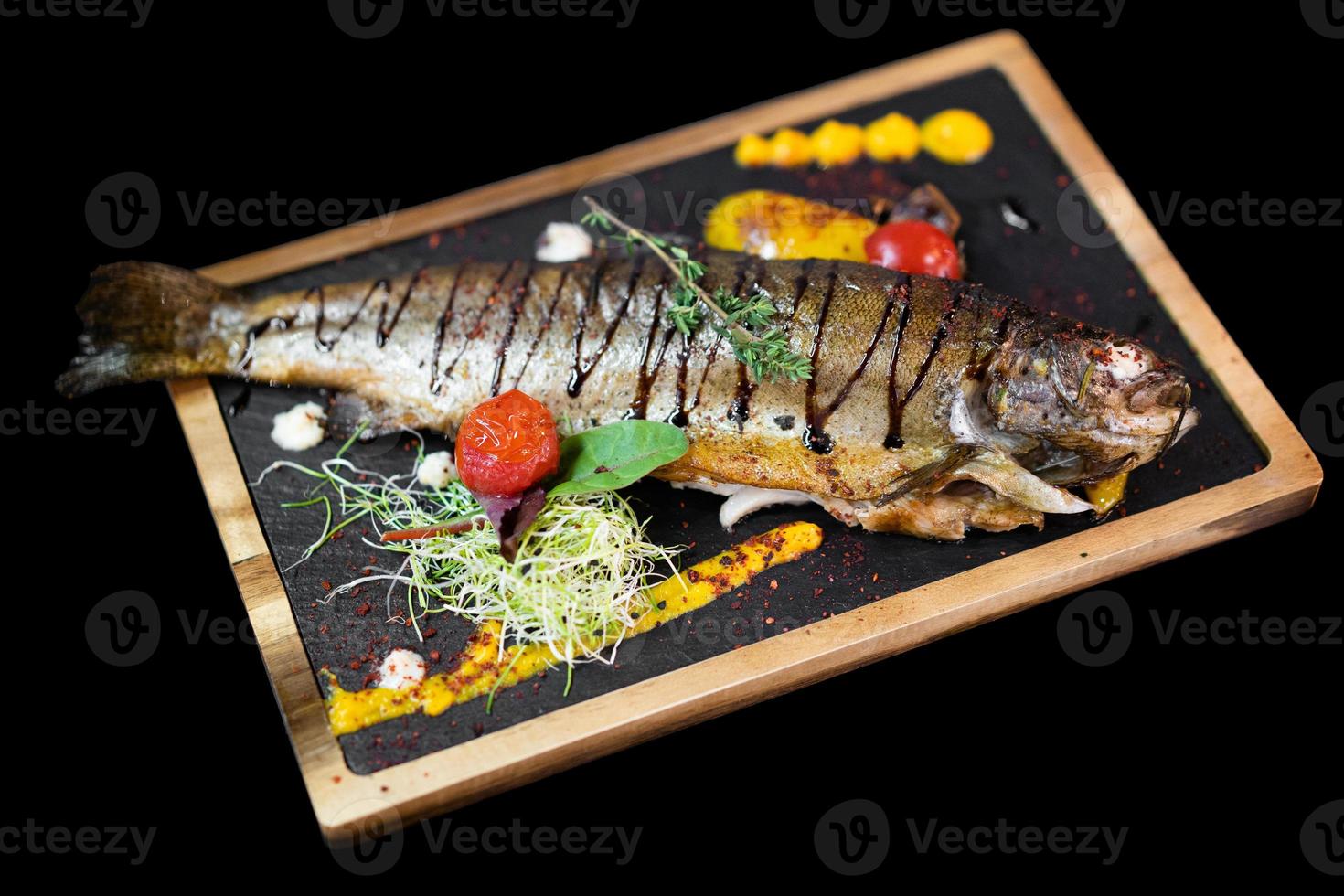 close up of an exquisite serving of a special dish from the chef on a black board photo