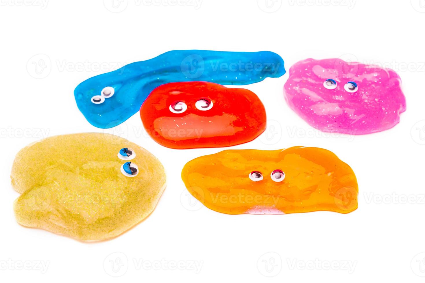 a toy for children mucus and liquid flowing which has eyes on white background photo