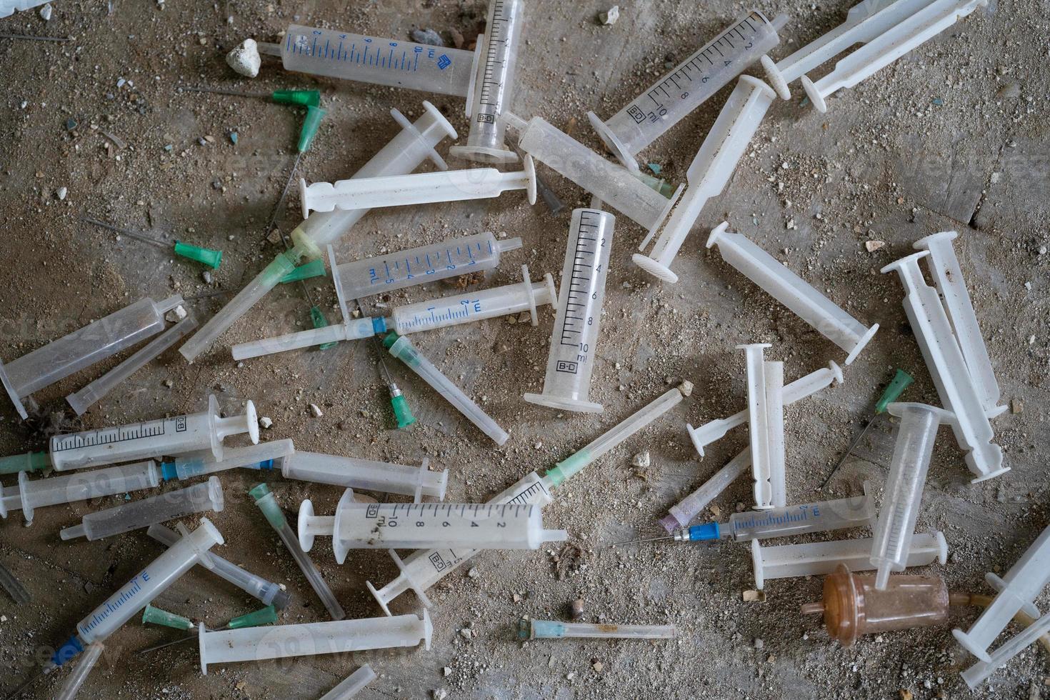 many dirty syringes and needles photo