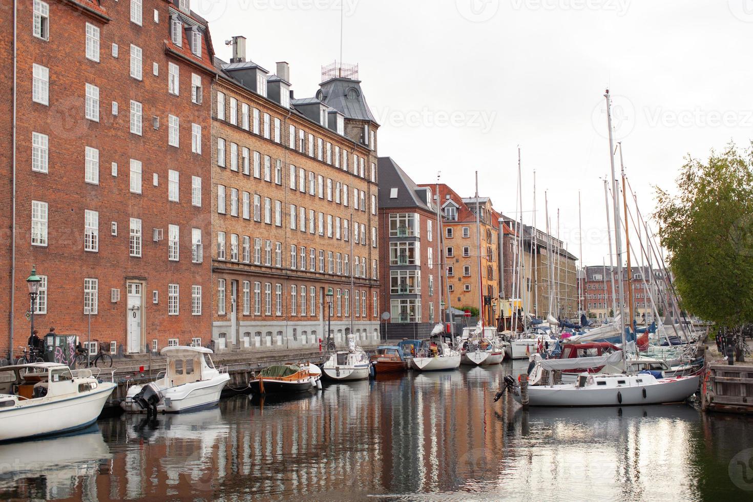 beautiful harbor with many boats in the canal between the houses. photo