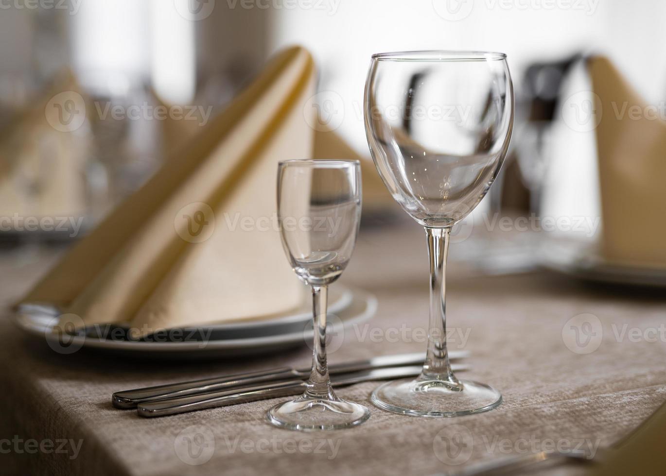 empty goblets and other cutlery are served on the festive table. photo