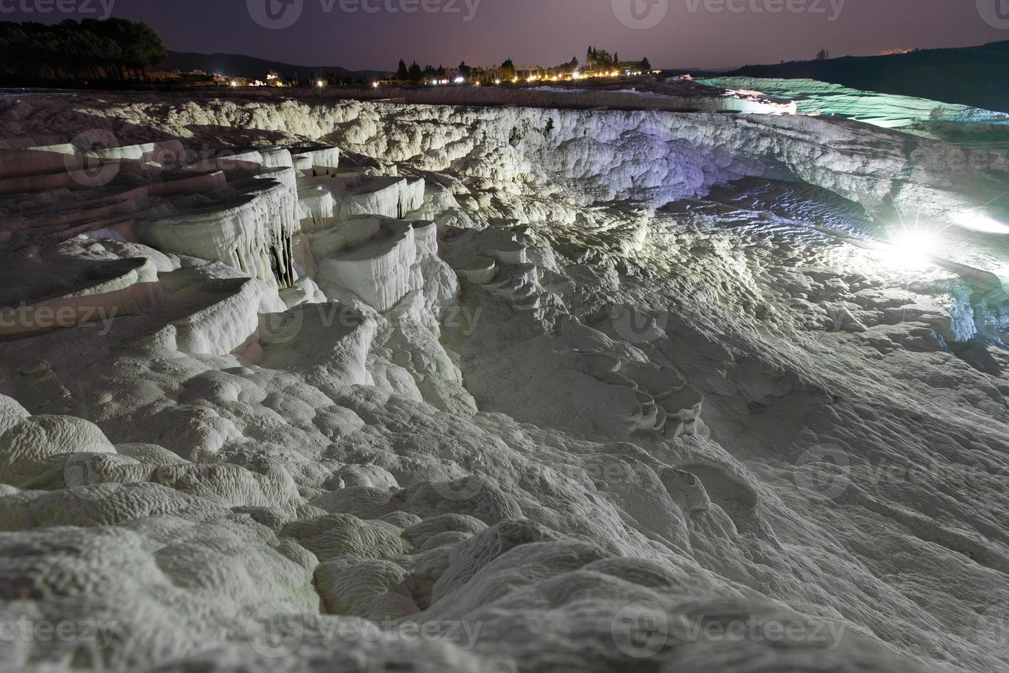 Pamukkale on the top with a view of the city of Denizli at night, Turkey. photo