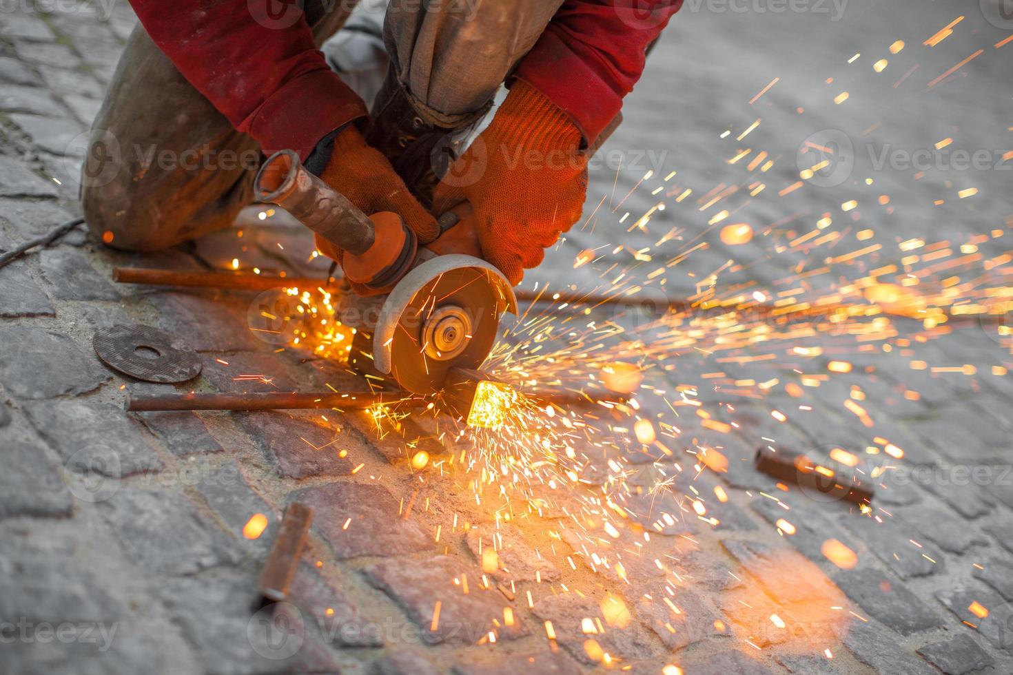 Angular grinding machine cuts metal with sparks photo