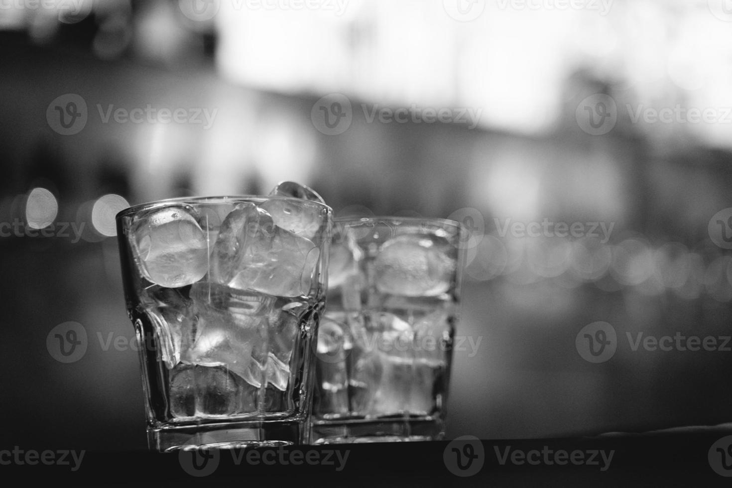 an alcoholic drink with ice is served by the bartender at the bar photo