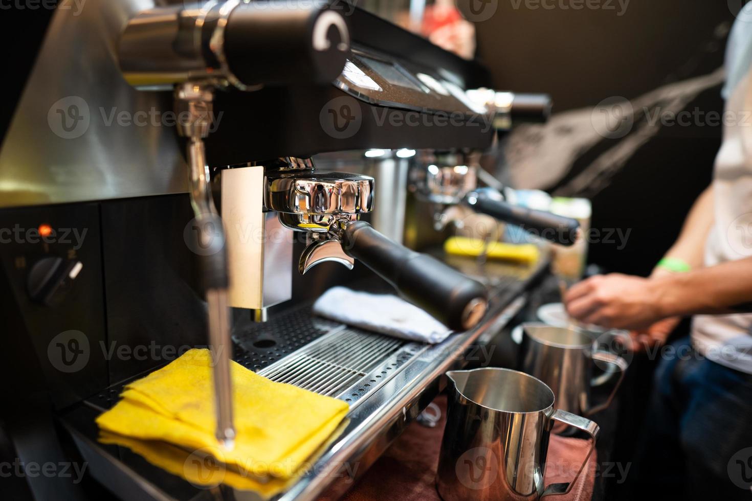 barista makes coffee in a coffee machine photo