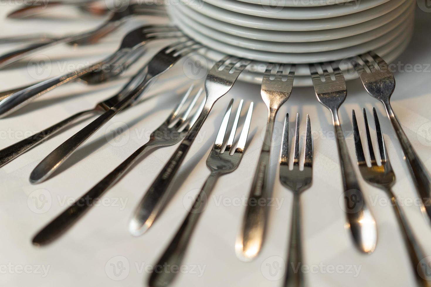 beautiful composition with forks and plates on a buffet table photo