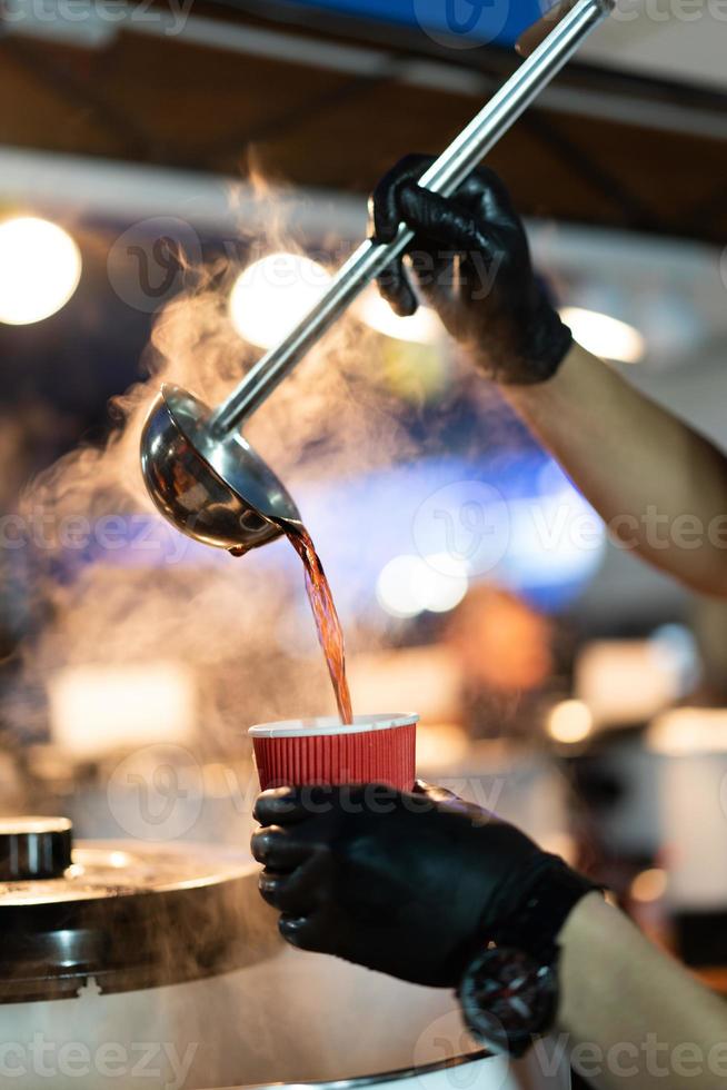 scoop poured into a glass of hot mulled wine photo