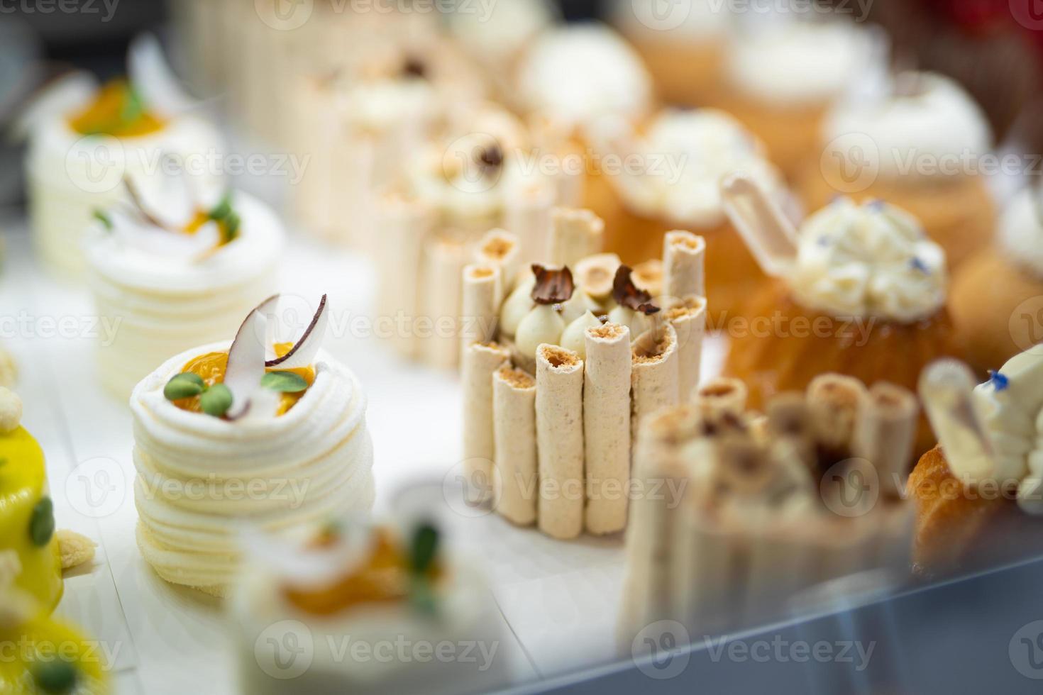 various delicious sweet pastries in the shop window. photo