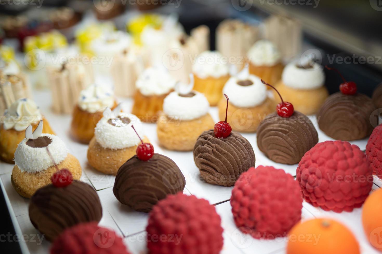 various delicious sweet pastries in the shop window. photo