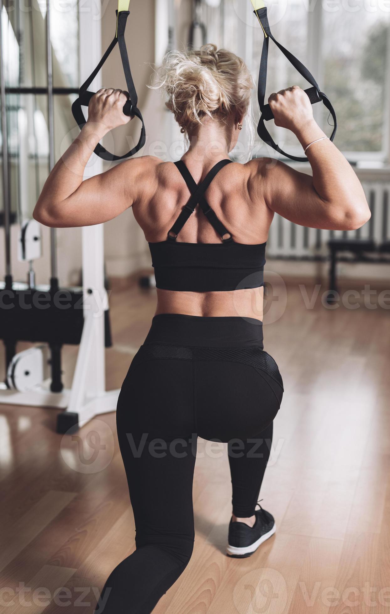 strong girl in the gym pumping her arms and back muscles on the exercise  machine. 17624378 Stock Photo at Vecteezy