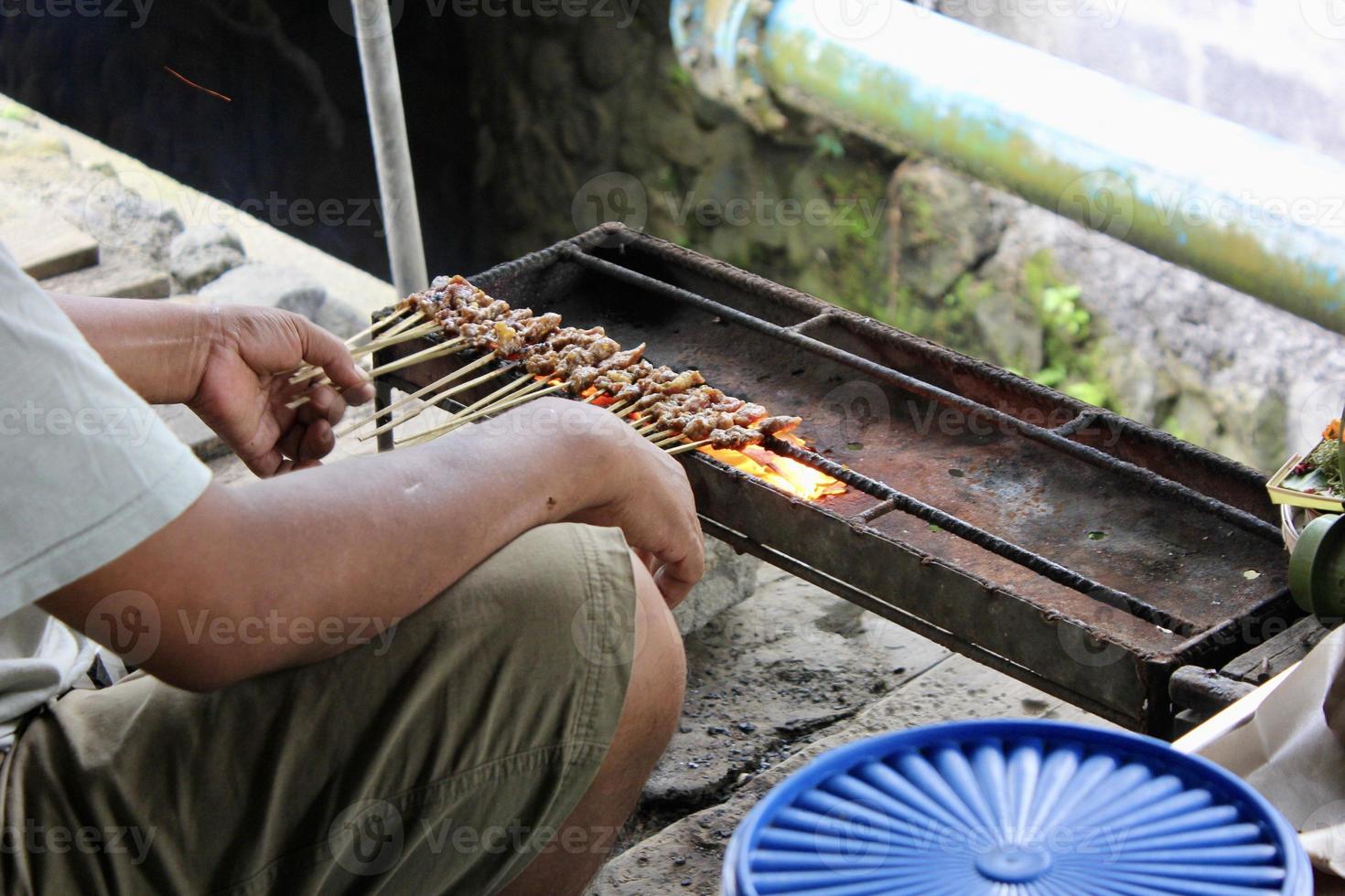 Photo of a pork satay making process in Bali.