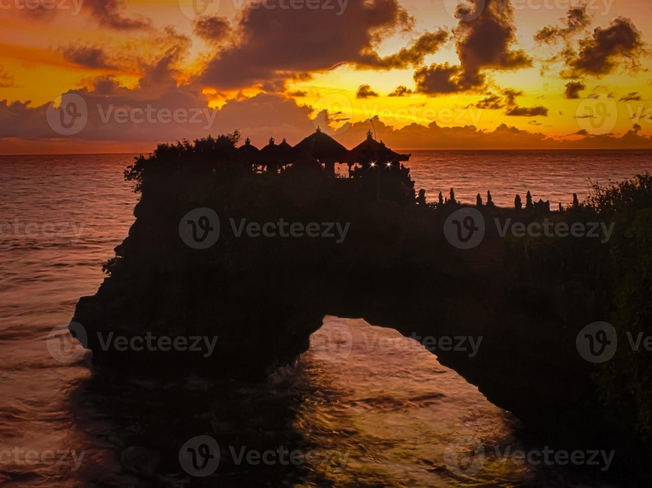 A beauty of sunset on Tanah Lot Temple in Bali. photo