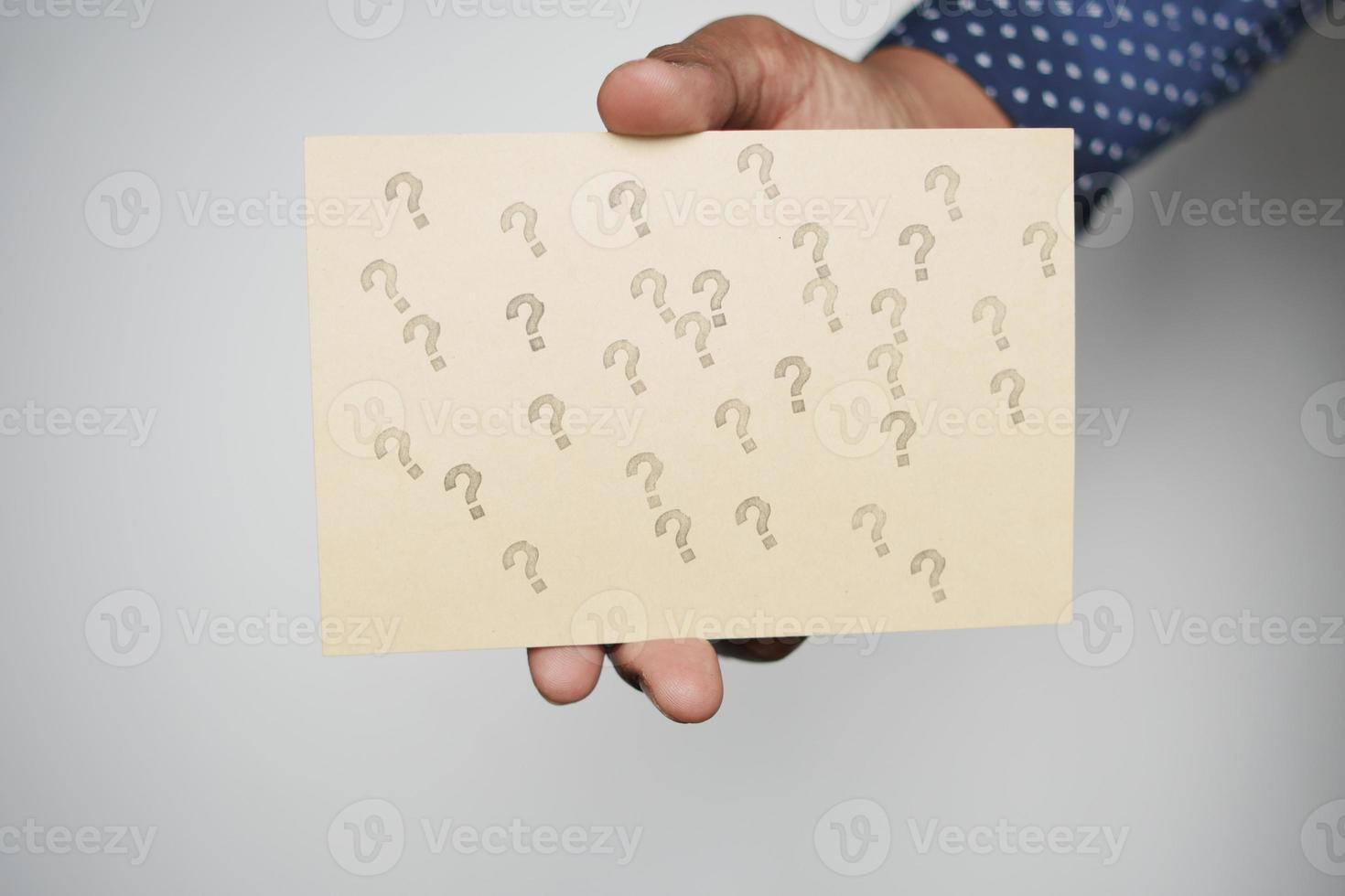 men holding a question mark on paper photo