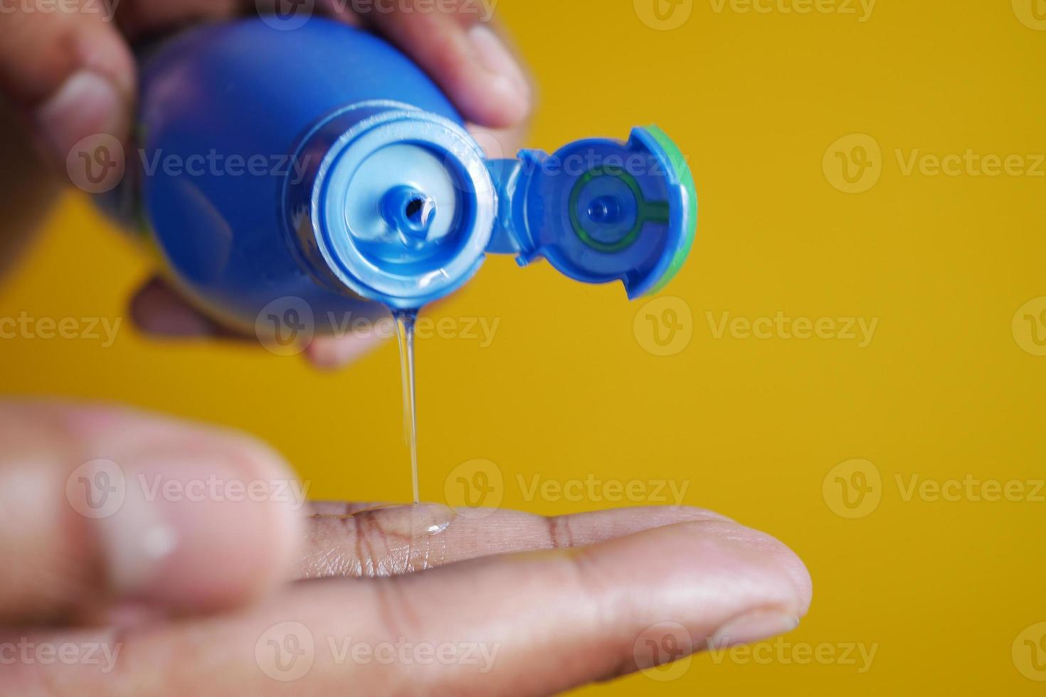 pouring hair oil on hand close up photo