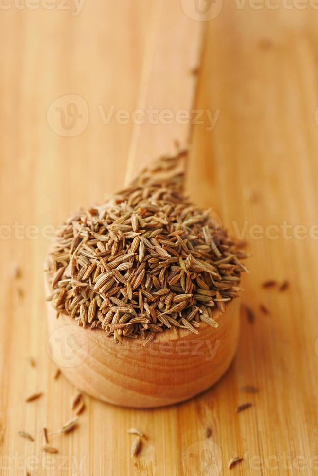 cumin seeds on spoon on table , close up photo