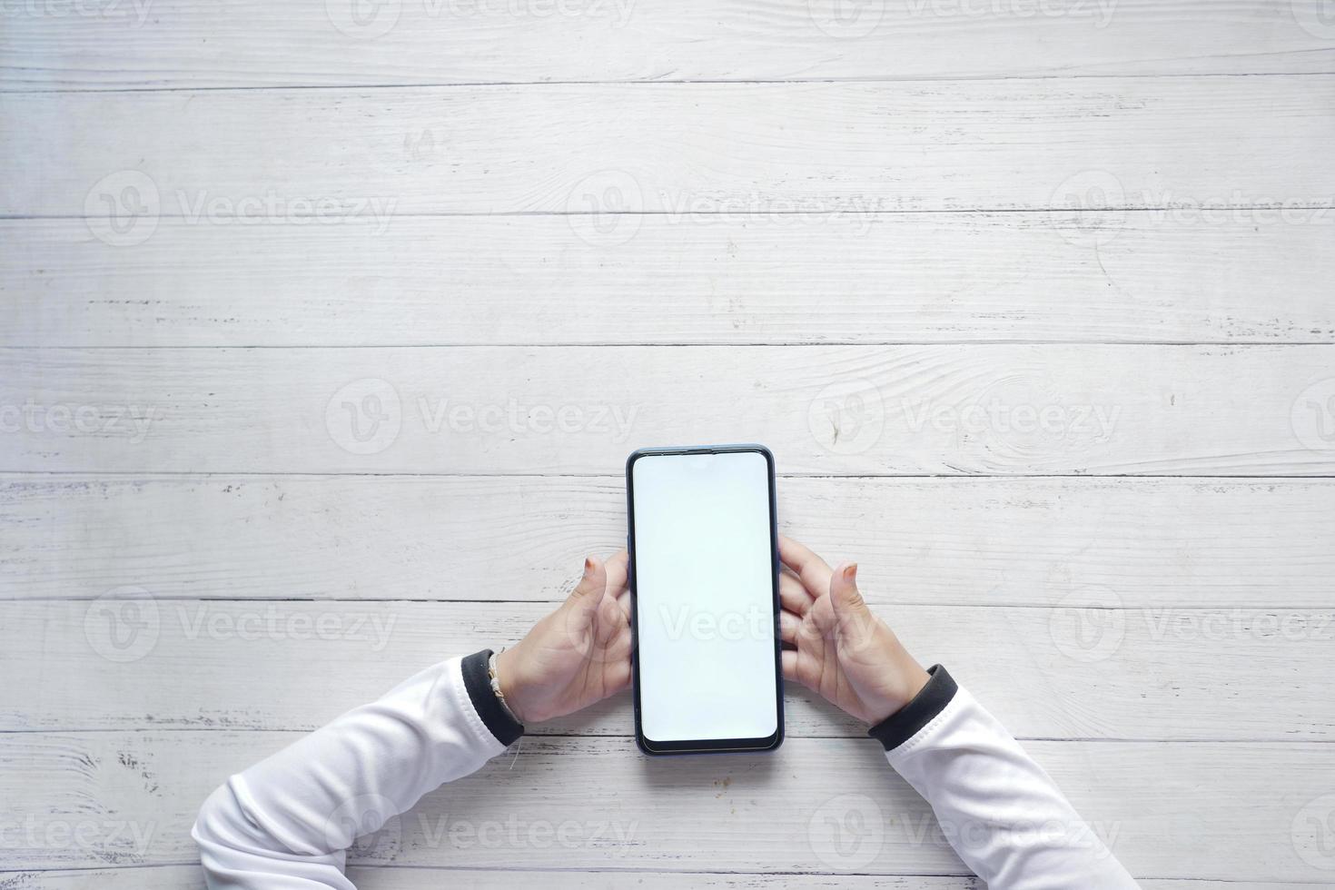 flat composition of child girl using smart phone on table photo