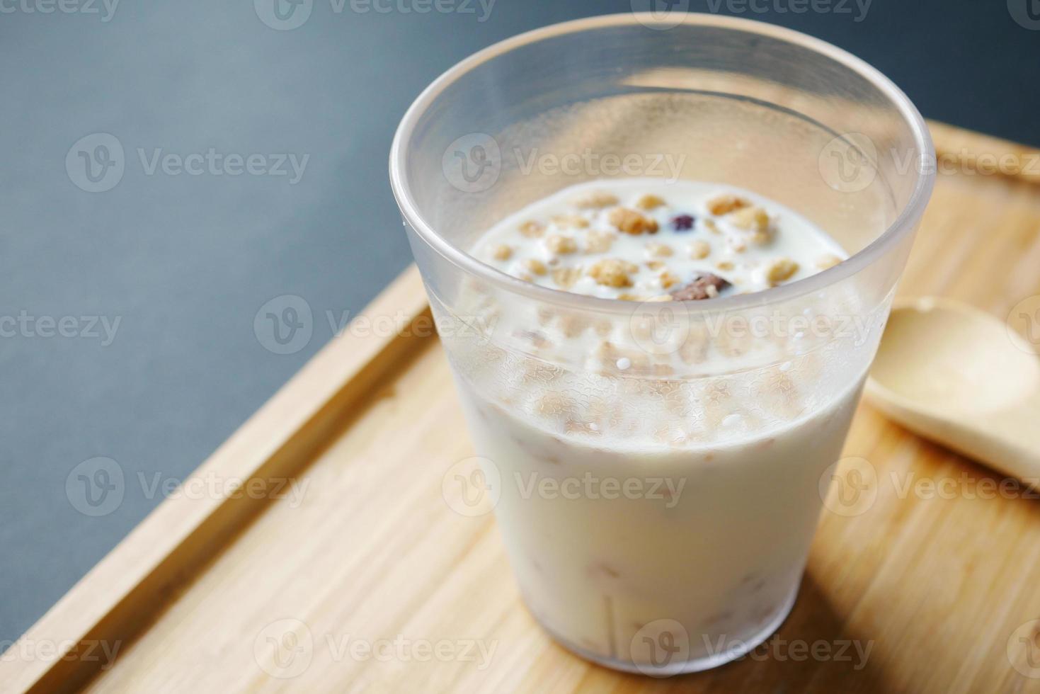 breakfast cereal and mixed with milk in a glass on table photo