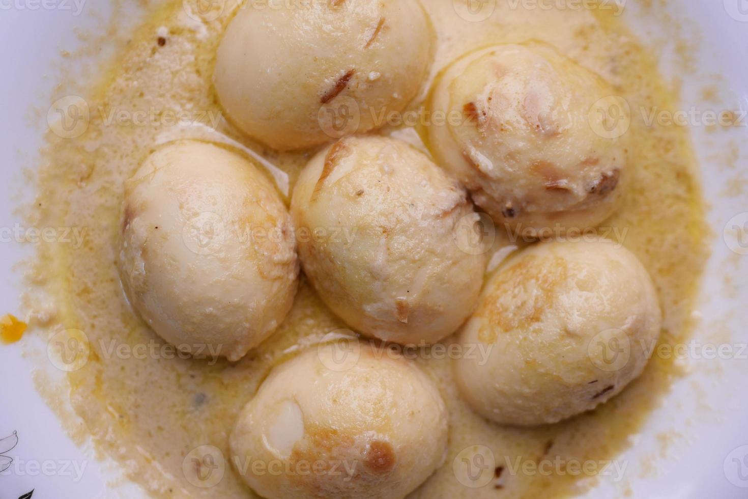 top view of Egg Curry in a bowl on table photo