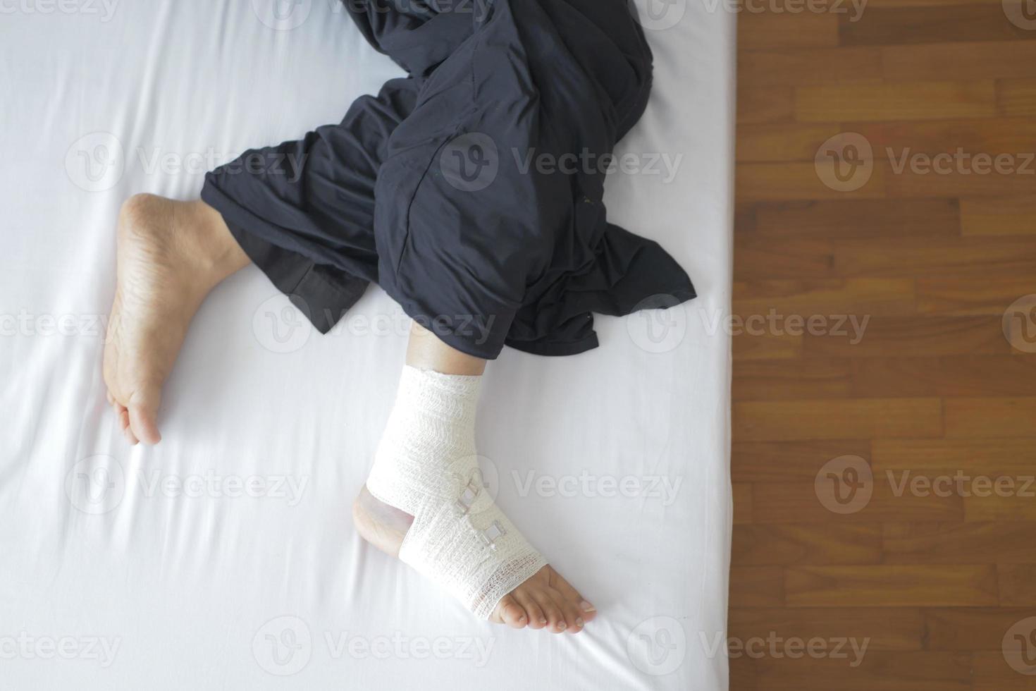 Woman with bandaged foot close up photo