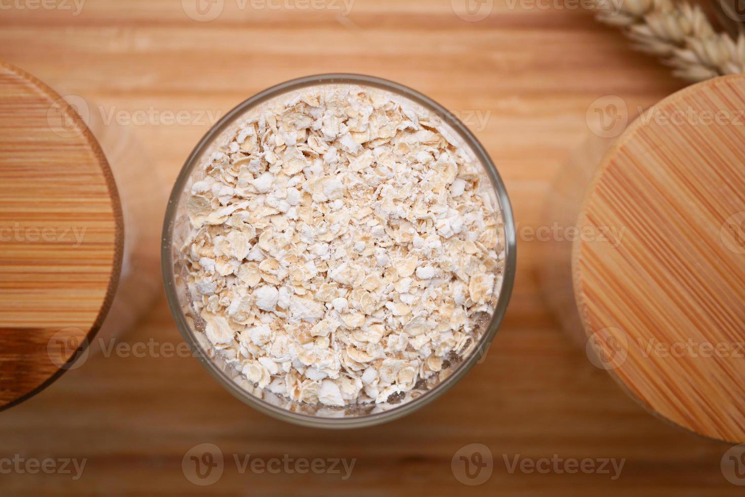uncooked oats flakes black background, top down photo