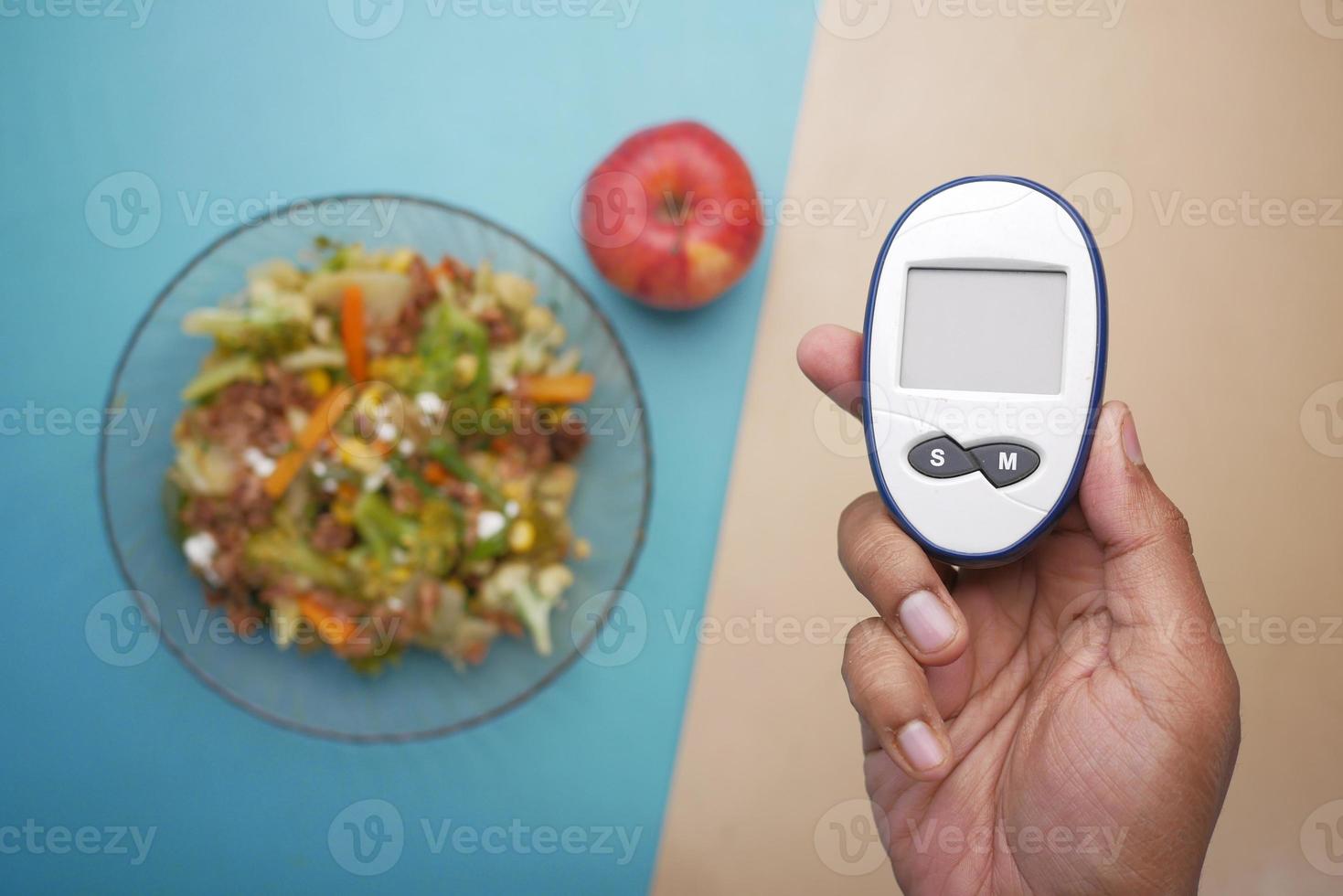 diabetic measurement tools and healthy food on table photo