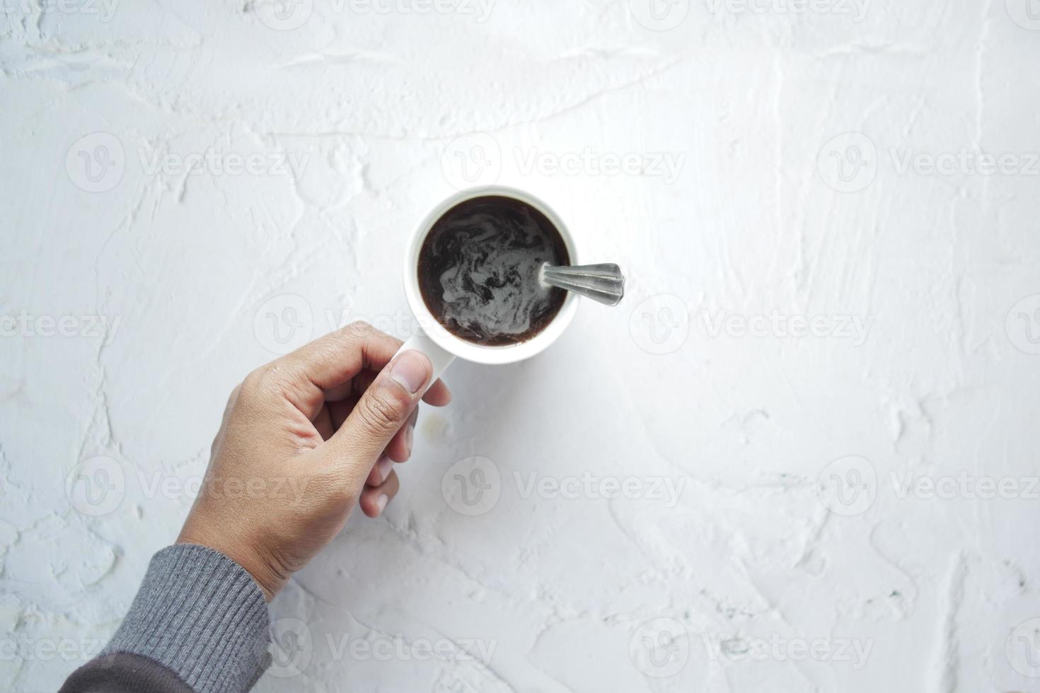 top view of men holding a coffee cup photo