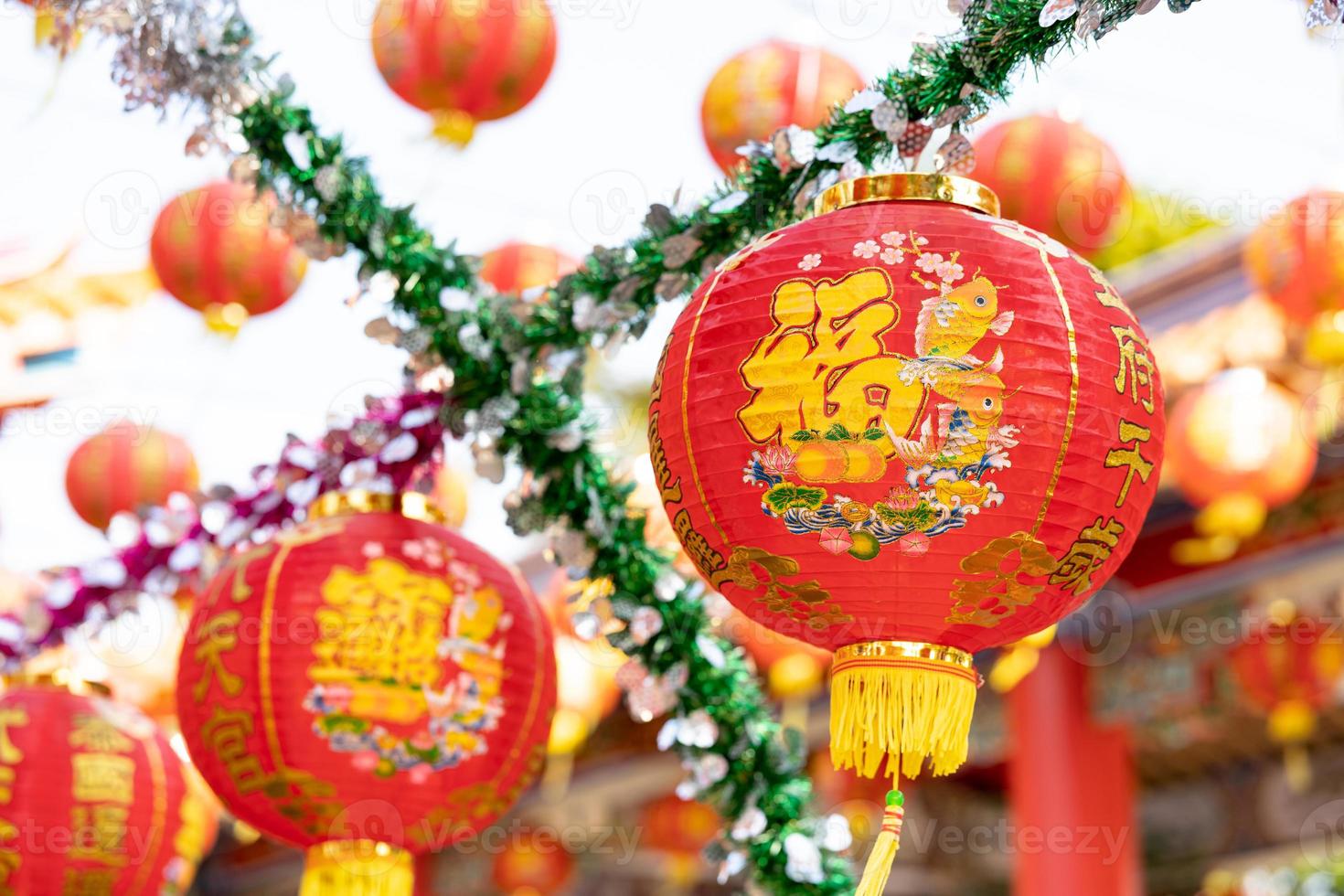 Chinese new year lanterns in Chinese shrine at Thailand with the text Thailand is like heaven. May the five lands live a thousand years. photo