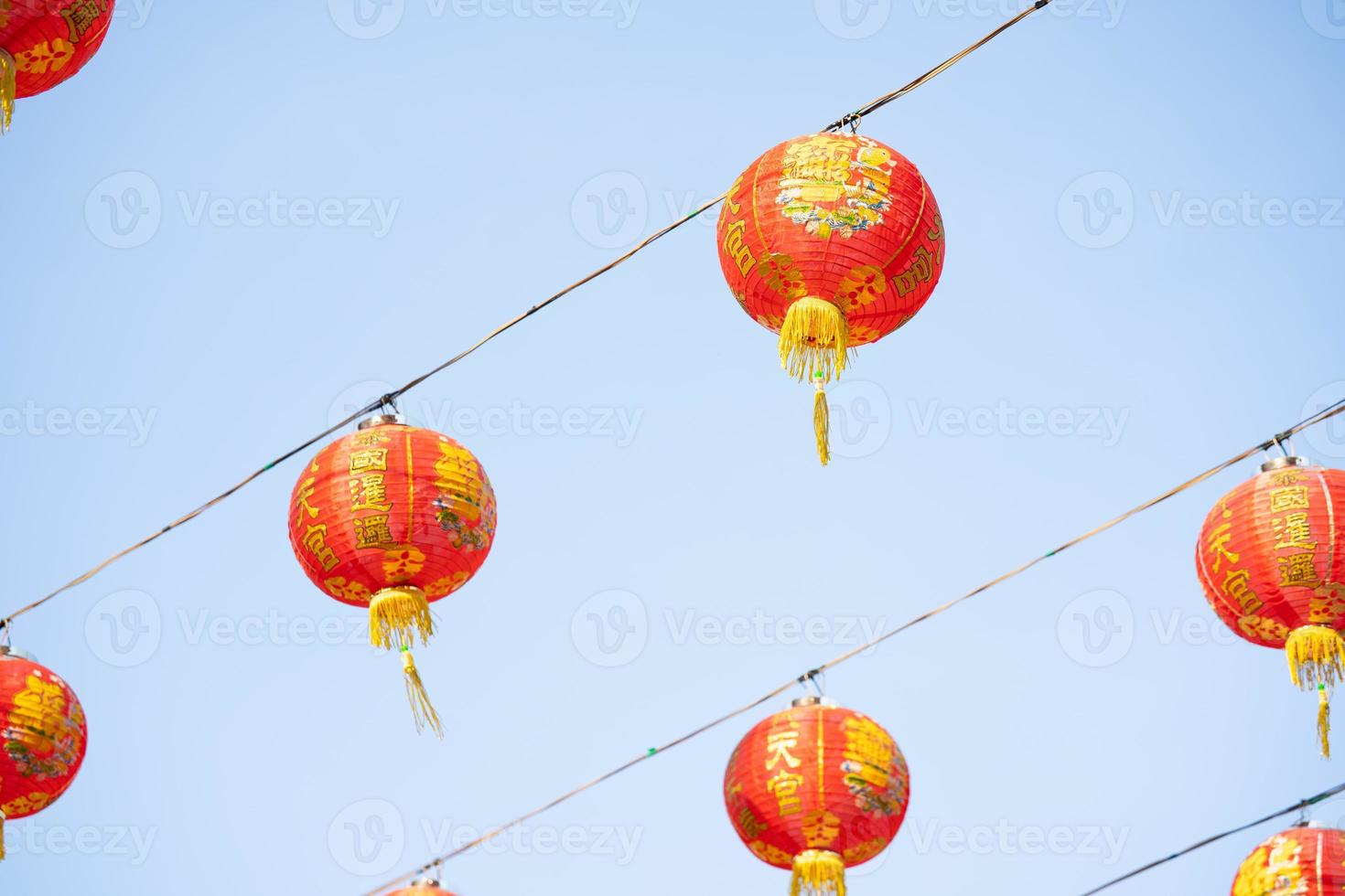 Chinese new year lanterns in Chinese shrine at Thailand with the text Thailand is like heaven. May the five lands live a thousand years. photo