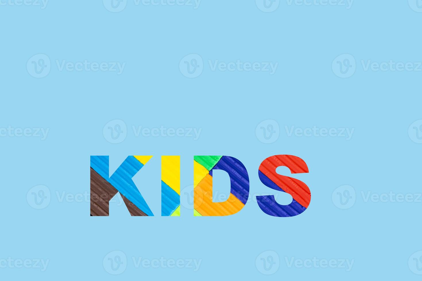 Multicolored kids plasticine, the word children written in plasticine letters. Blue isolated background photo