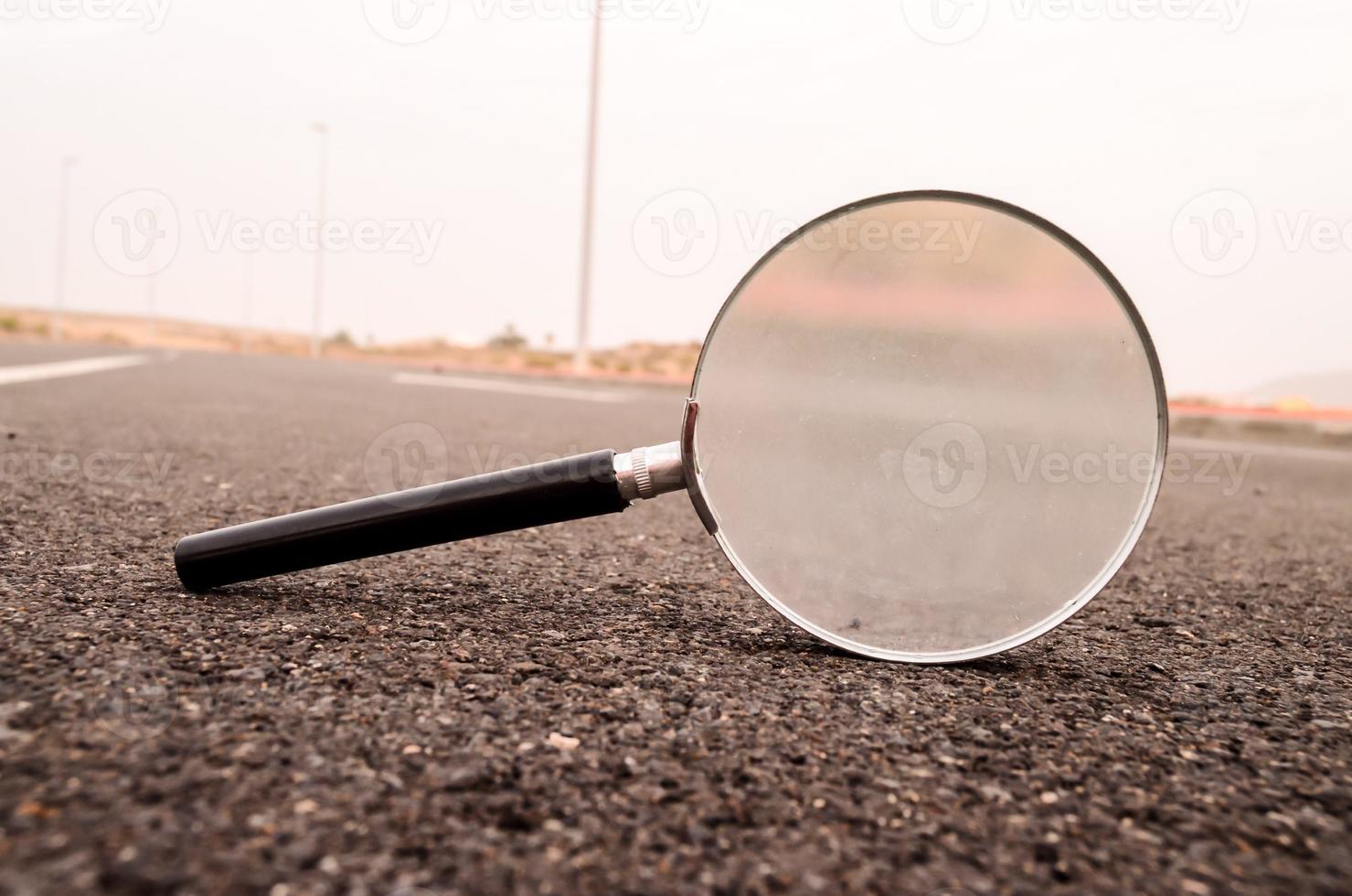 Magnifying glass on the road photo