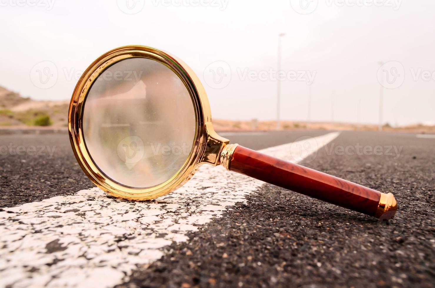 Magnifying glass on the road photo