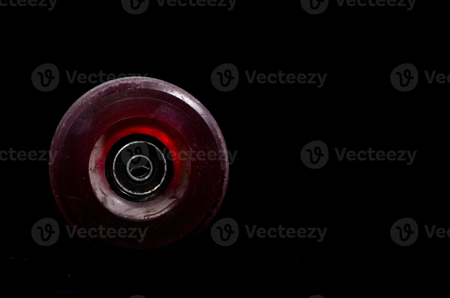 Skateboard wheel on black background photo