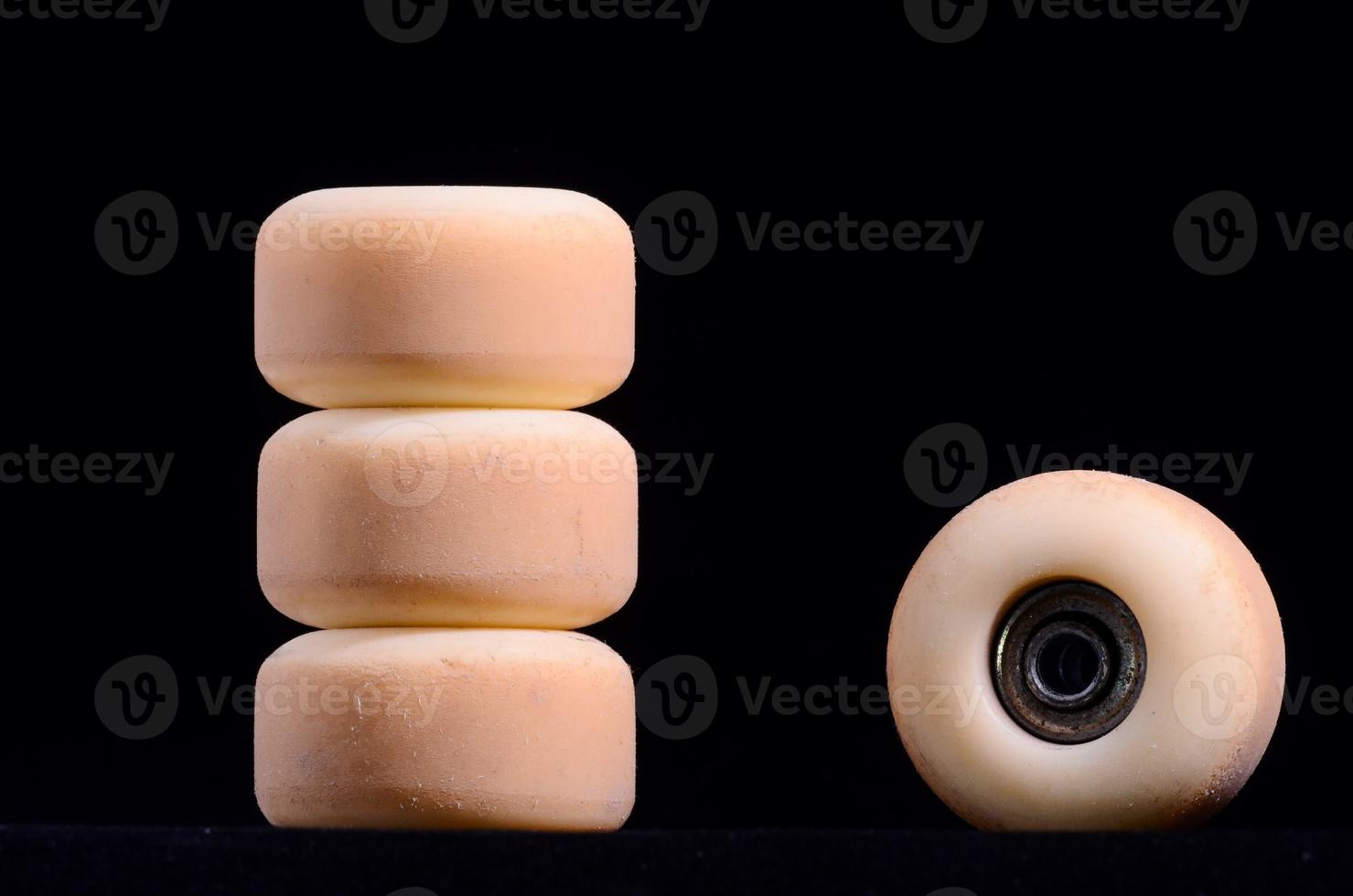 Skateboard wheels on black background photo